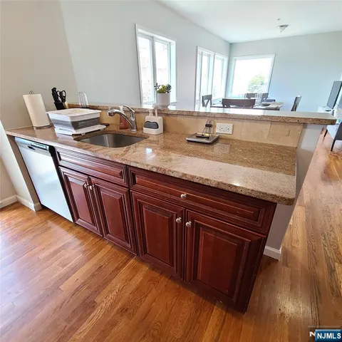 a living room with granite countertop furniture and a wooden floor