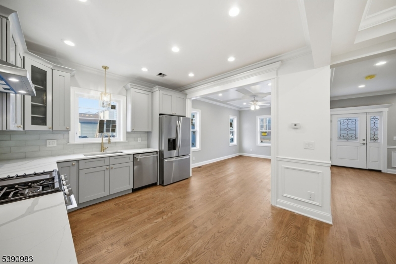 a large kitchen with cabinets and wooden floor