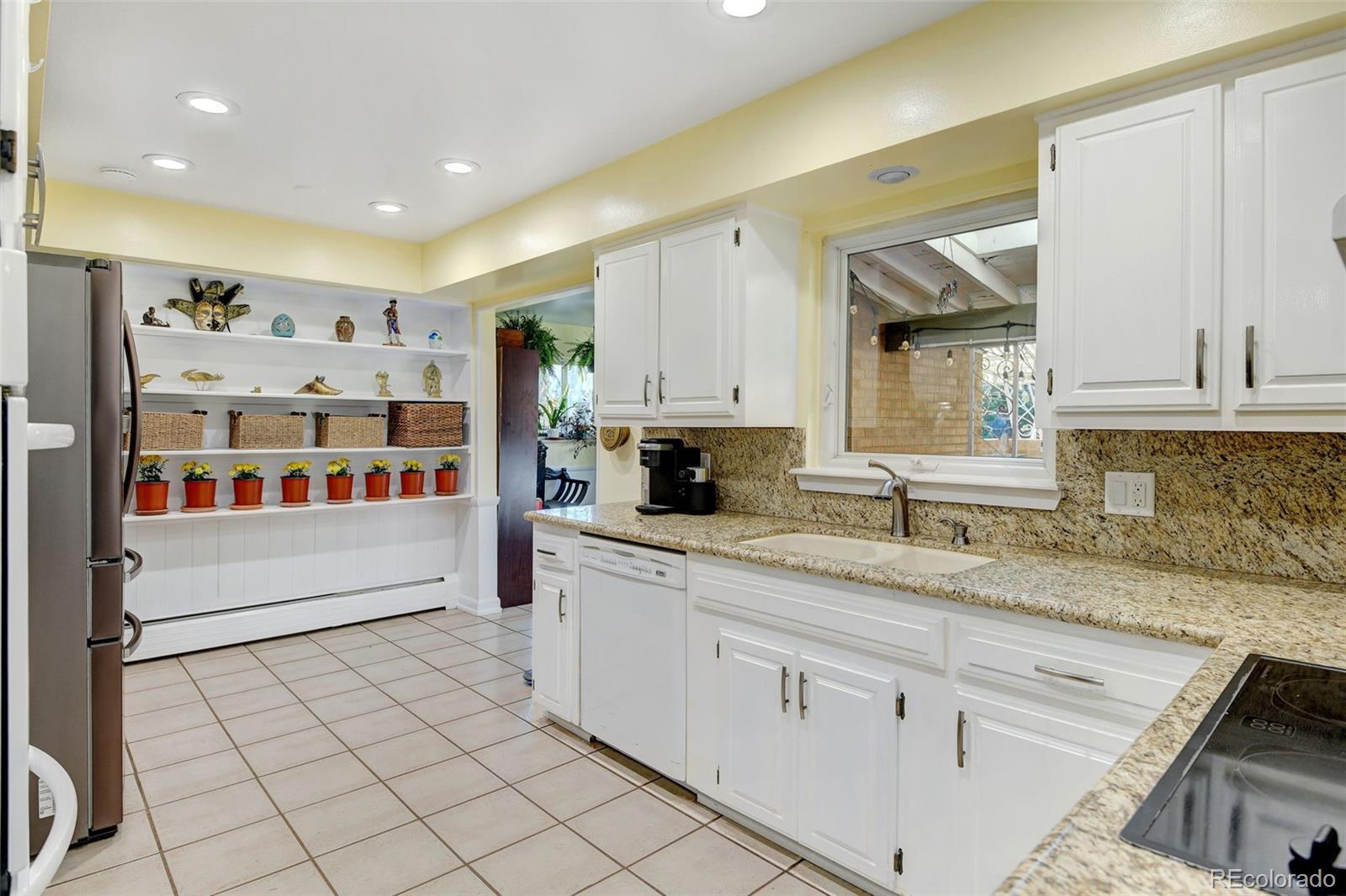 3515 Otis Street Wheat Ridge, CO 80033 - Photo 12 of 37 a large white kitchen with a lot of counter space and a sink