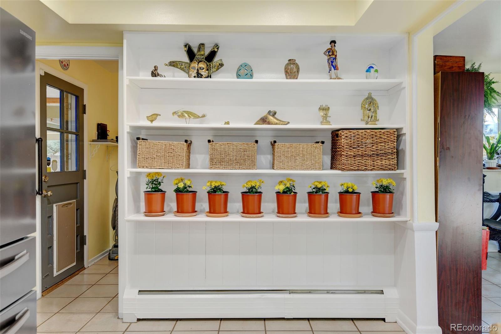 3515 Otis Street Wheat Ridge, CO 80033 - Photo 14 of 37 a room with lots of books and knick knacks on it