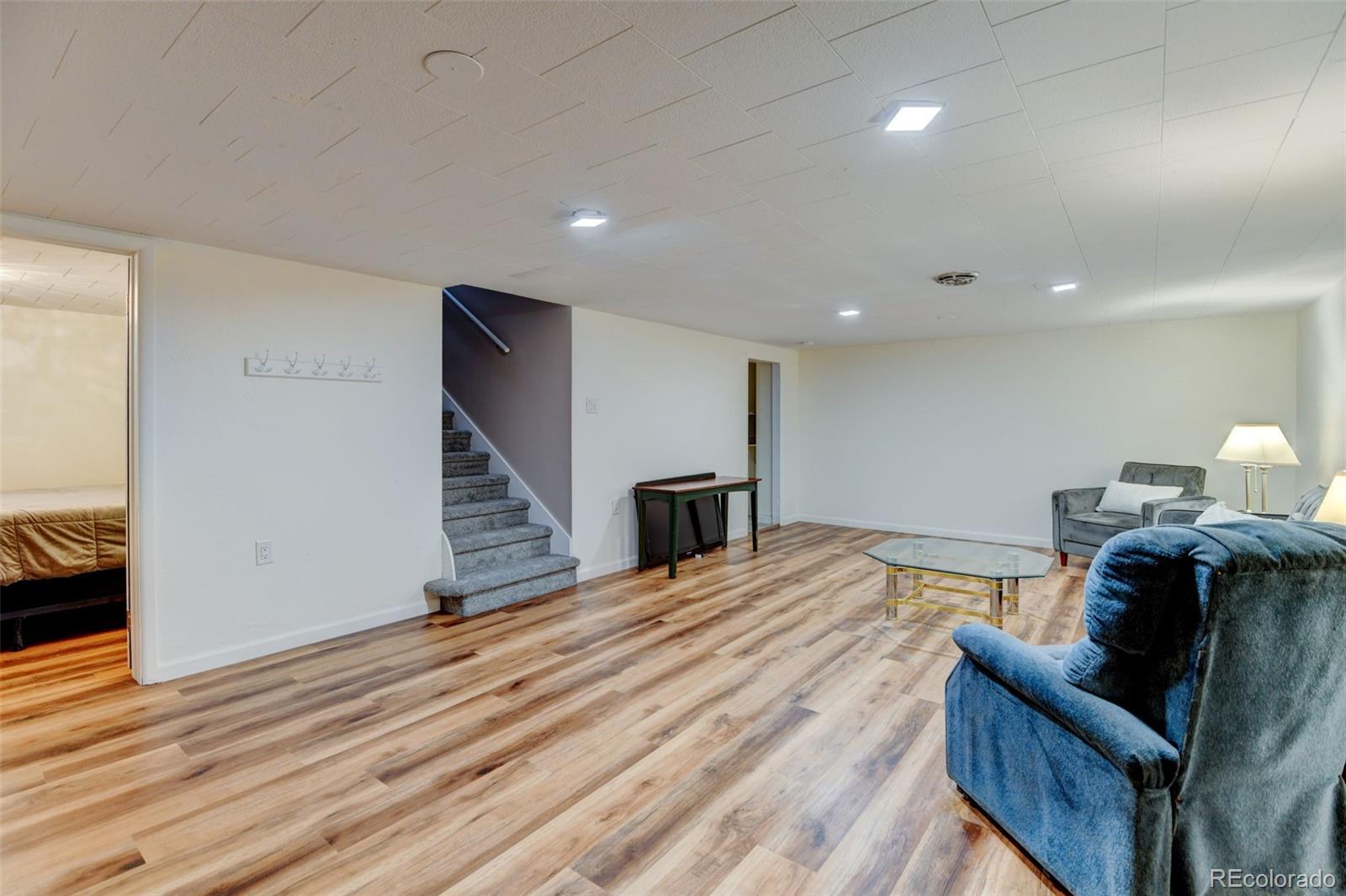 3515 Otis Street Wheat Ridge, CO 80033 - Photo 22 of 37 a view of a bedroom with furniture and wooden floor