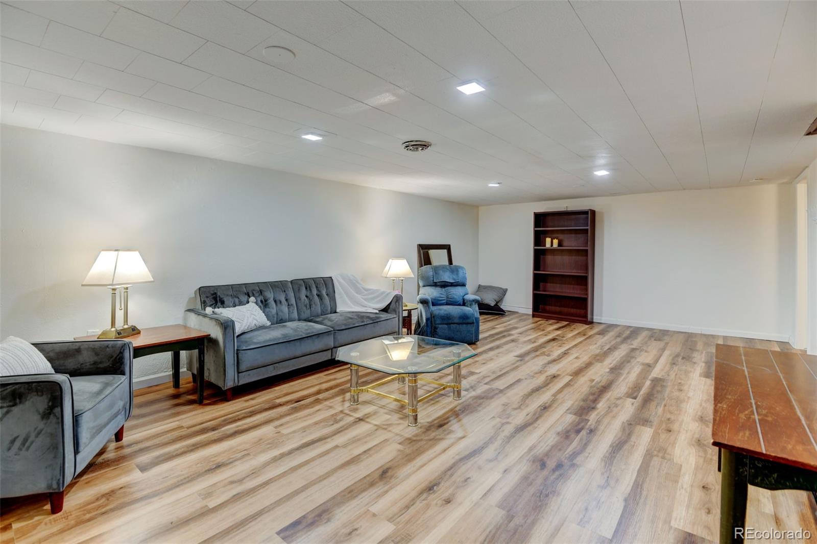 3515 Otis Street Wheat Ridge, CO 80033 - Photo 23 of 37 a living room with furniture and a lamp