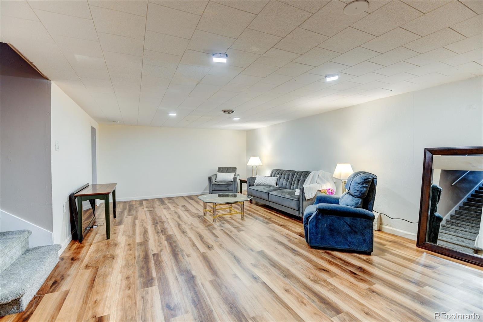 3515 Otis Street Wheat Ridge, CO 80033 - Photo 24 of 37 a living room with furniture and a wooden floor