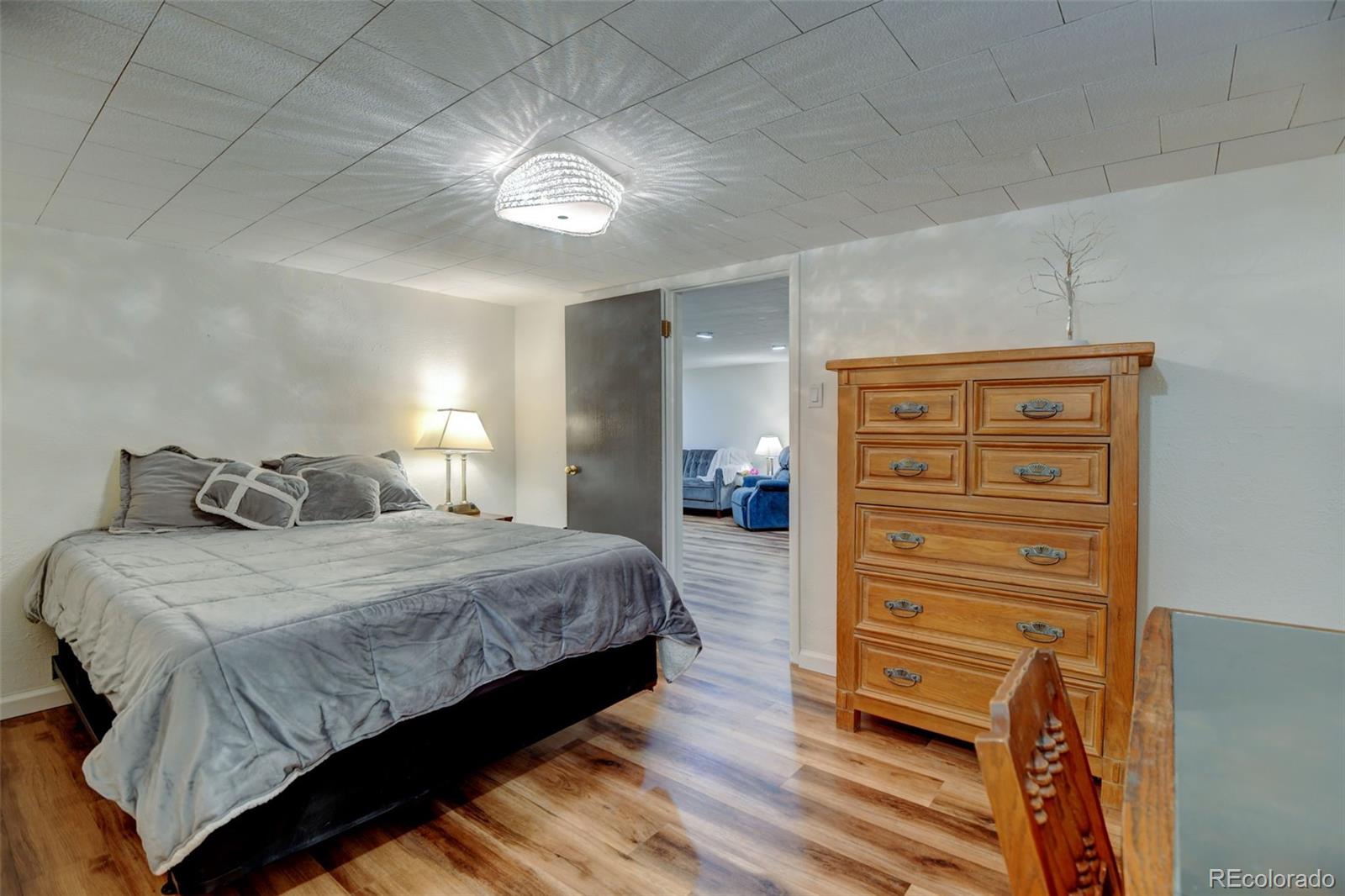 3515 Otis Street Wheat Ridge, CO 80033 - Photo 25 of 37 a bedroom with a bed and a dresser