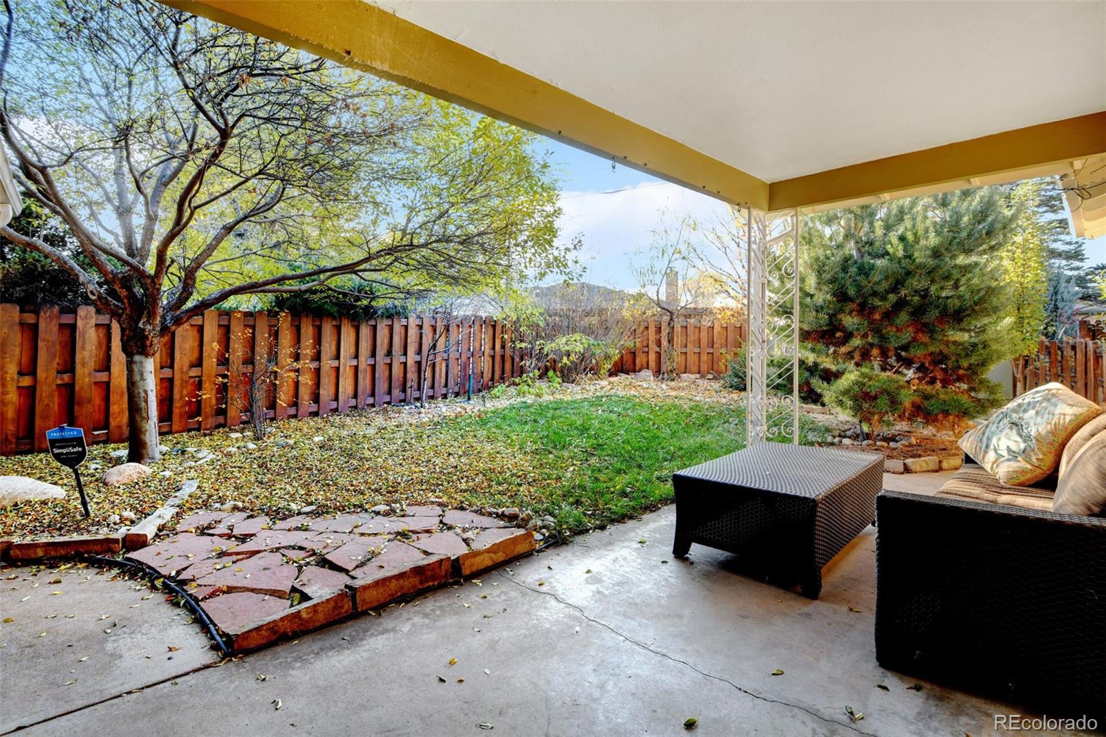 3515 Otis Street Wheat Ridge, CO 80033 - Photo 31 of 37 a backyard of a house with barbeque oven table and chairs