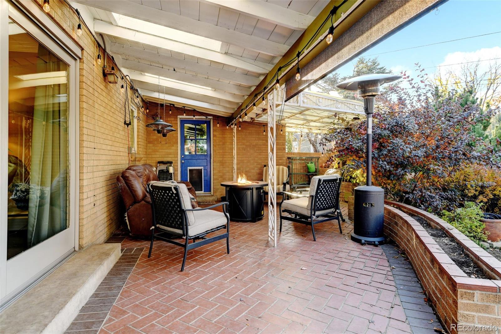 3515 Otis Street Wheat Ridge, CO 80033 - Photo 35 of 37 a living room with patio furniture and a wooden floor