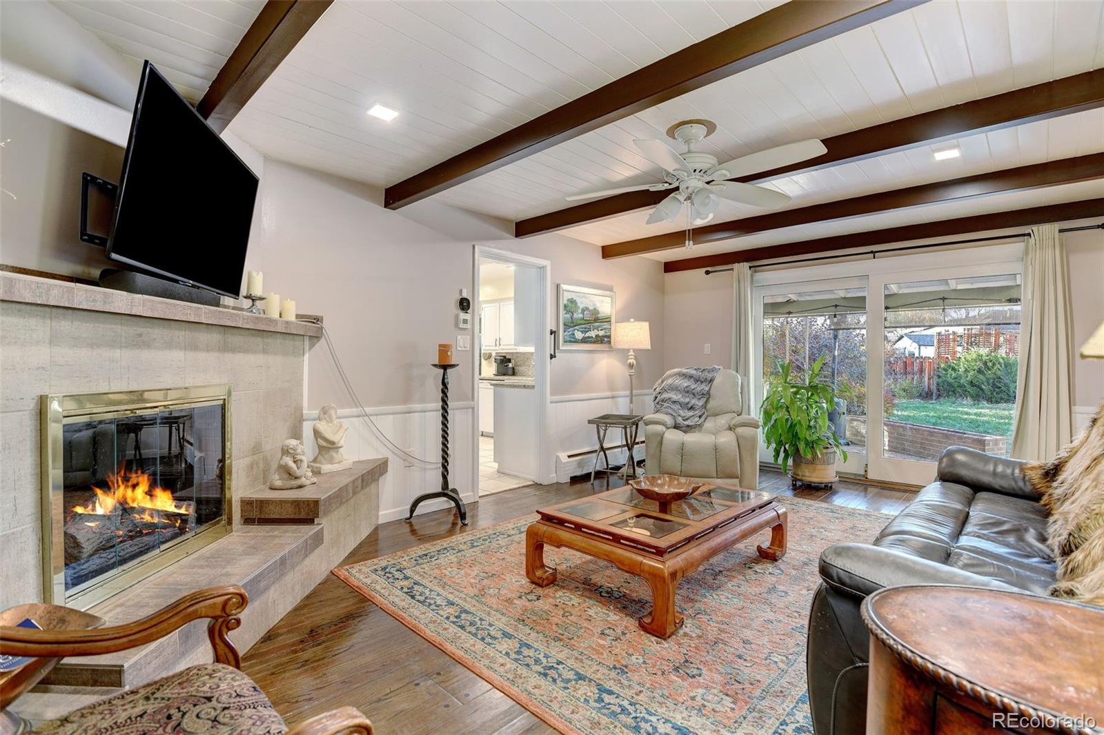 3515 Otis Street Wheat Ridge, CO 80033 - Photo 7 of 37 a living room with furniture fireplace and flat screen tv