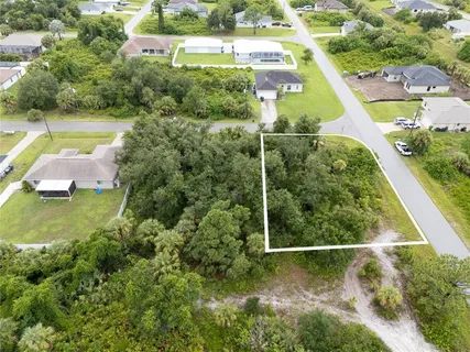 an aerial view of a residential houses with outdoor space and street view