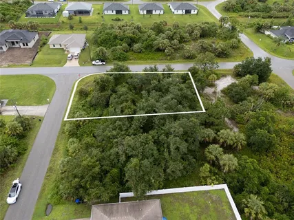 an aerial view of a house with a yard