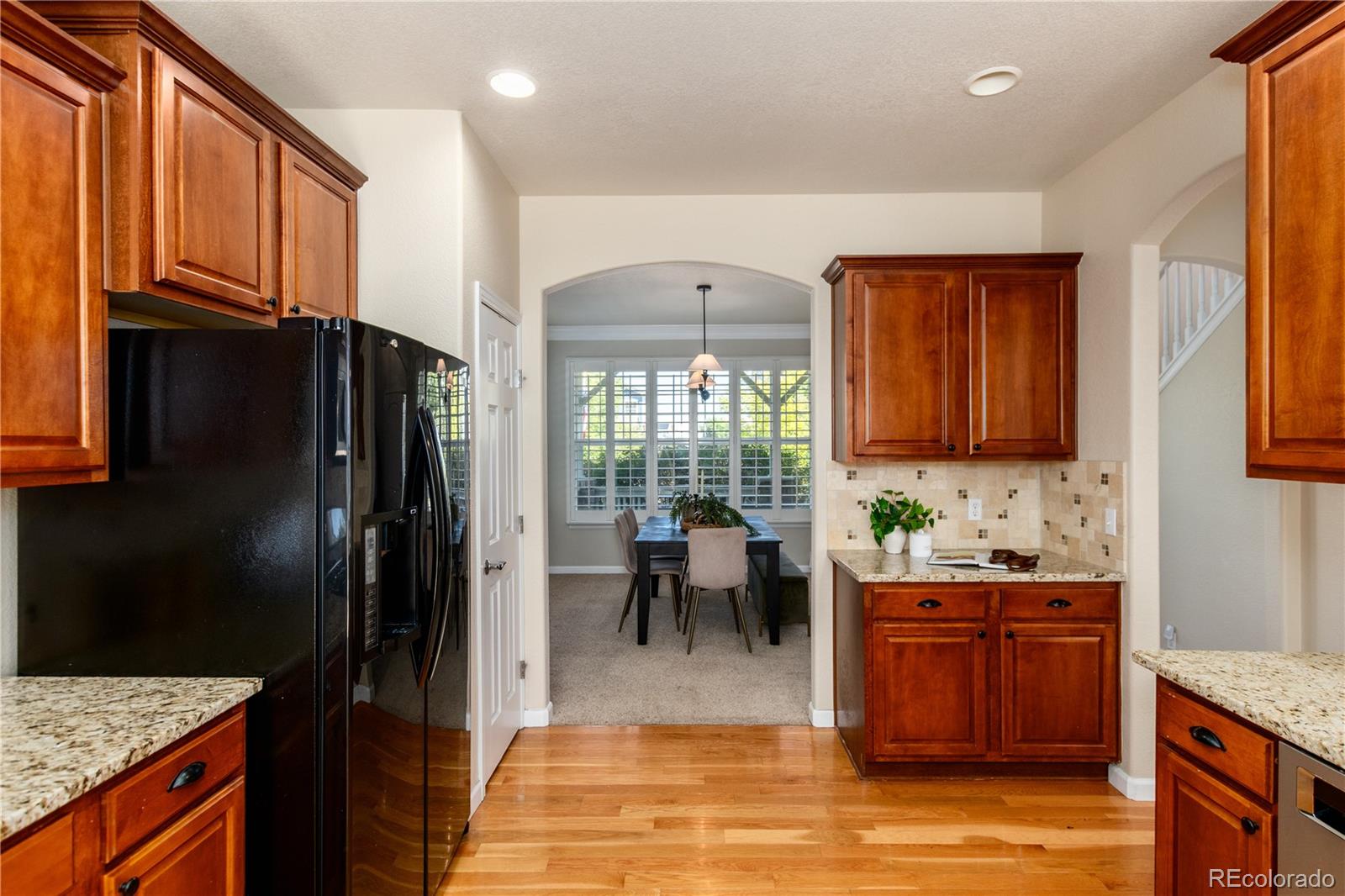 3064 Rams Horn Run Broomfield, CO 80023 - Photo 11 of 47 a kitchen with stainless steel appliances granite countertop a refrigerator and a stove top oven