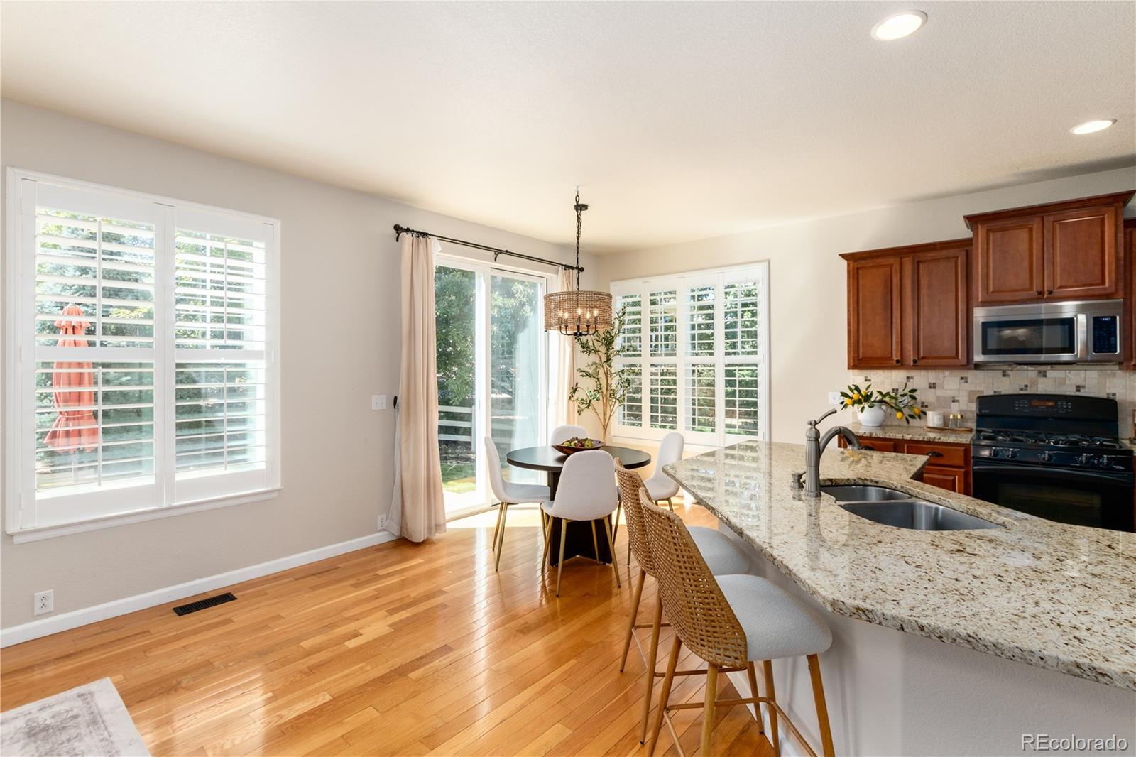 3064 Rams Horn Run Broomfield, CO 80023 - Photo 13 of 47 a living room with fireplace furniture and a wooden floor