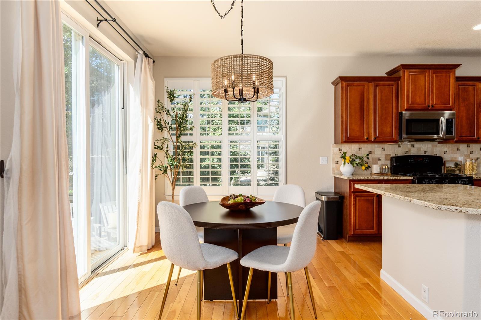 3064 Rams Horn Run Broomfield, CO 80023 - Photo 15 of 47 a kitchen with stainless steel appliances granite countertop a stove a sink and a microwave