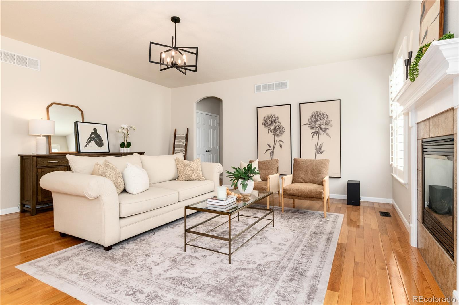 3064 Rams Horn Run Broomfield, CO 80023 - Photo 18 of 47 a living room with furniture and a chandelier