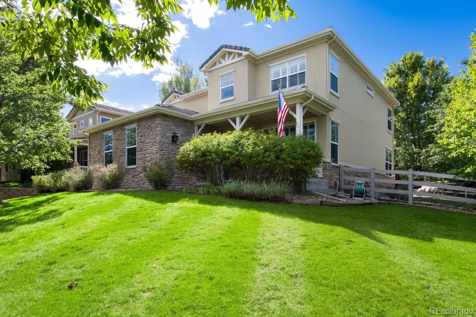 3064 Rams Horn Run Broomfield, CO 80023 - Photo 2 of 47 a front view of a house with a garden and plants