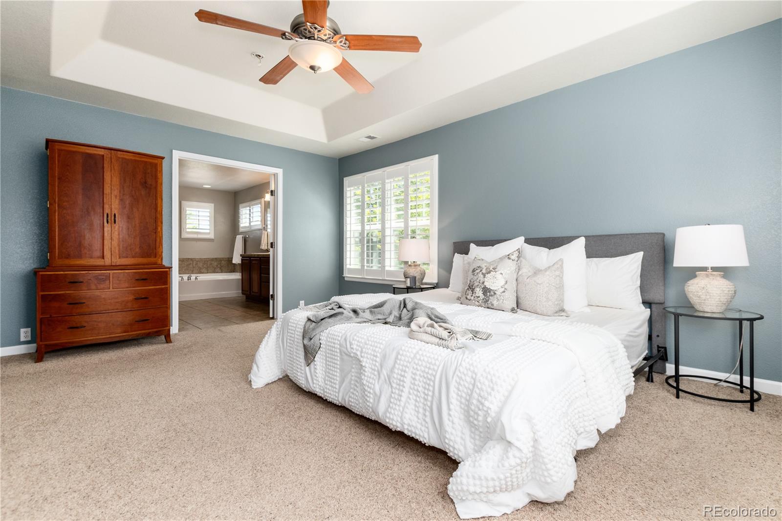3064 Rams Horn Run Broomfield, CO 80023 - Photo 25 of 47 a spacious bedroom with a bed a dresser and a chandelier