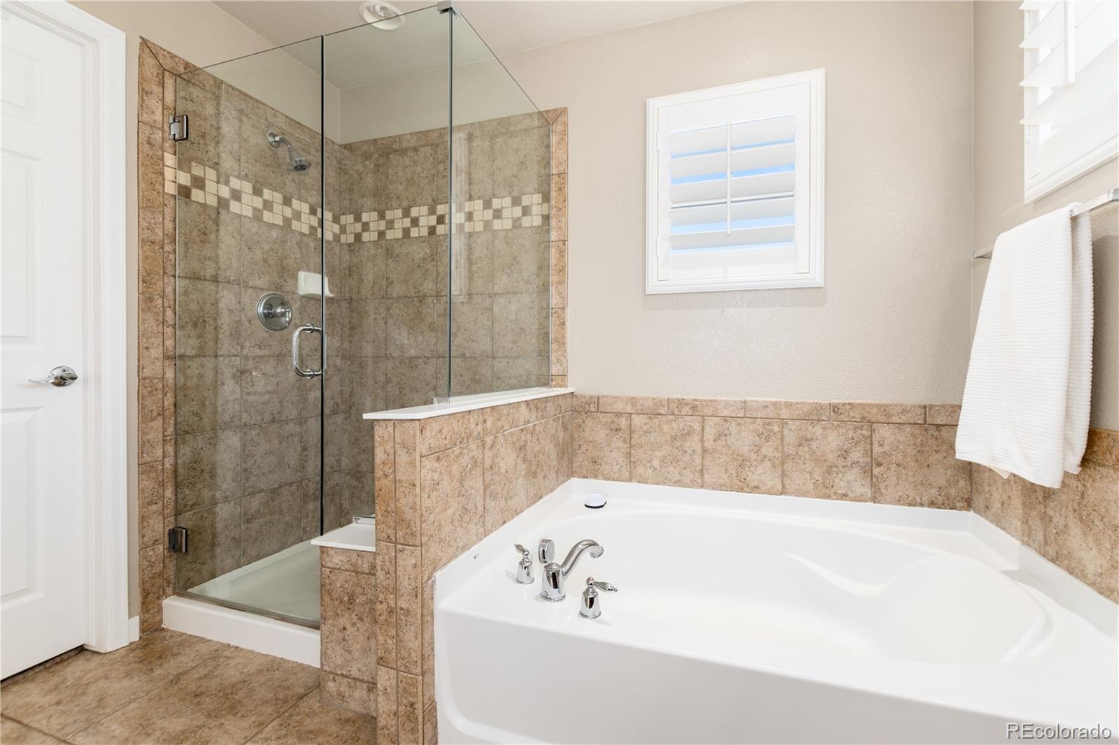 3064 Rams Horn Run Broomfield, CO 80023 - Photo 27 of 47 a bathroom with a bathtub and a shower