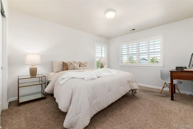 a bedroom with a bed and a desk