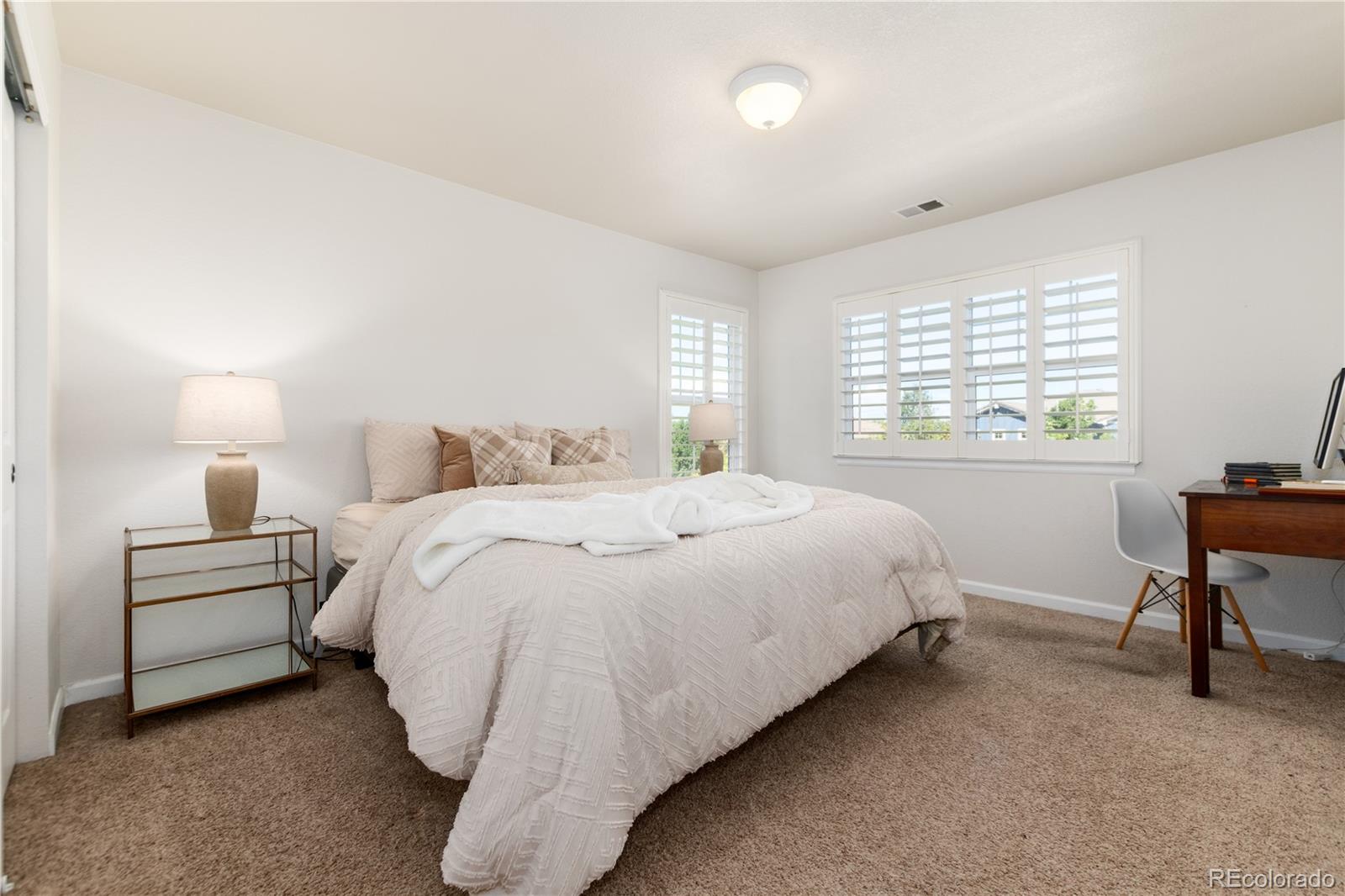 3064 Rams Horn Run Broomfield, CO 80023 - Photo 30 of 47 a bedroom with a bed and a desk
