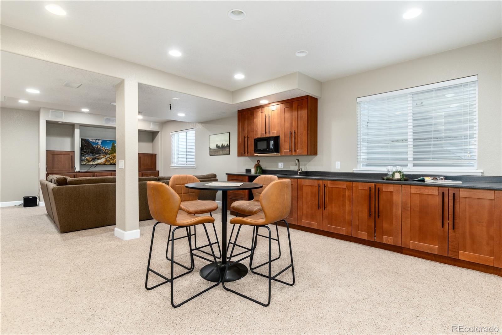 3064 Rams Horn Run Broomfield, CO 80023 - Photo 32 of 47 a kitchen with stainless steel appliances granite countertop a stove a sink a refrigerator and chairs
