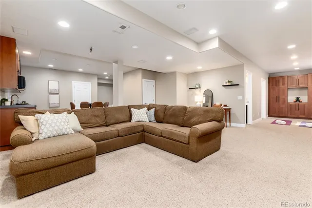 a living room with furniture and a large mirror