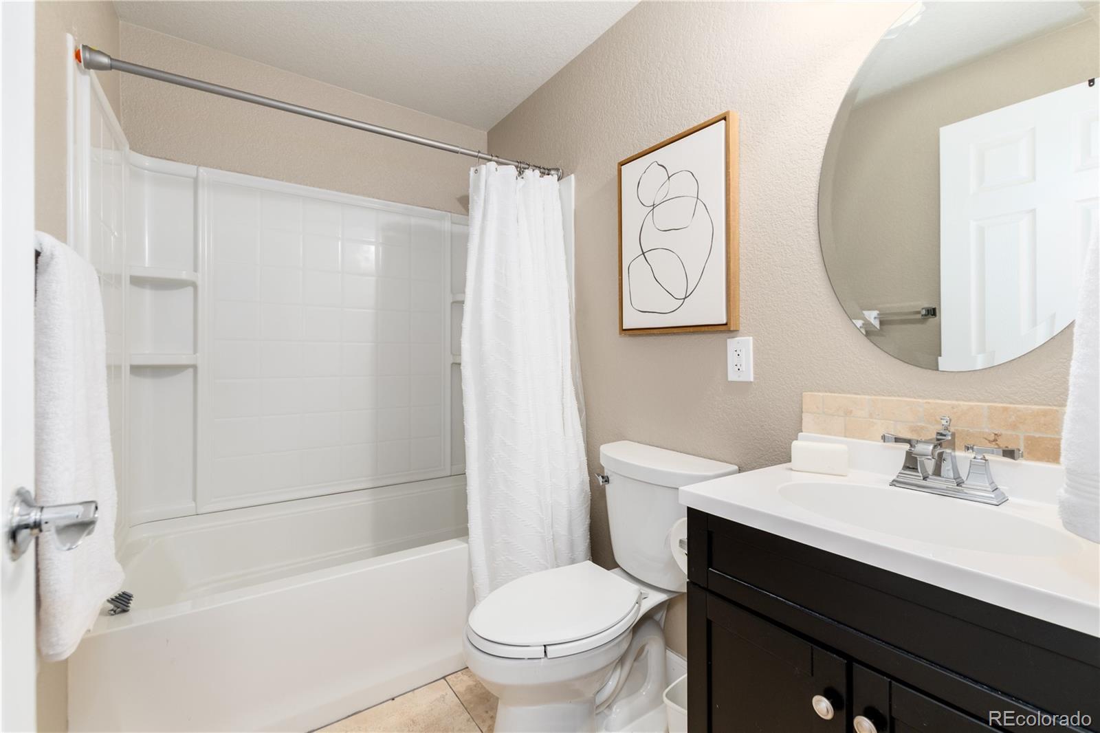 3064 Rams Horn Run Broomfield, CO 80023 - Photo 37 of 47 a bathroom with a sink a toilet and a mirror
