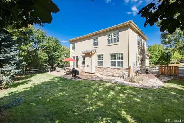 a view of a house with backyard sitting area and garden