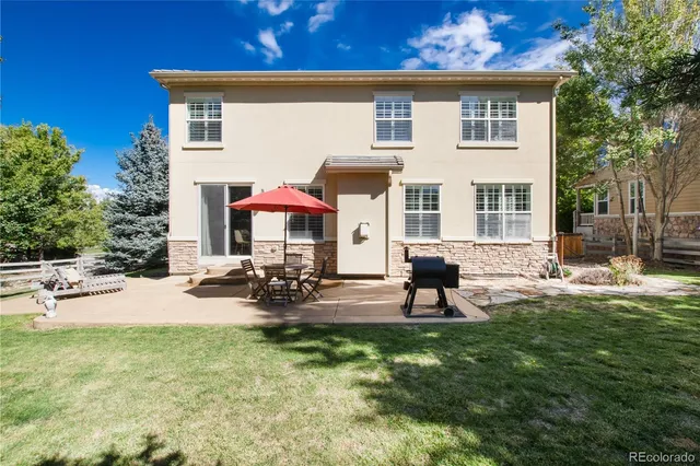 a view of a lounge chairs in back yard of the house