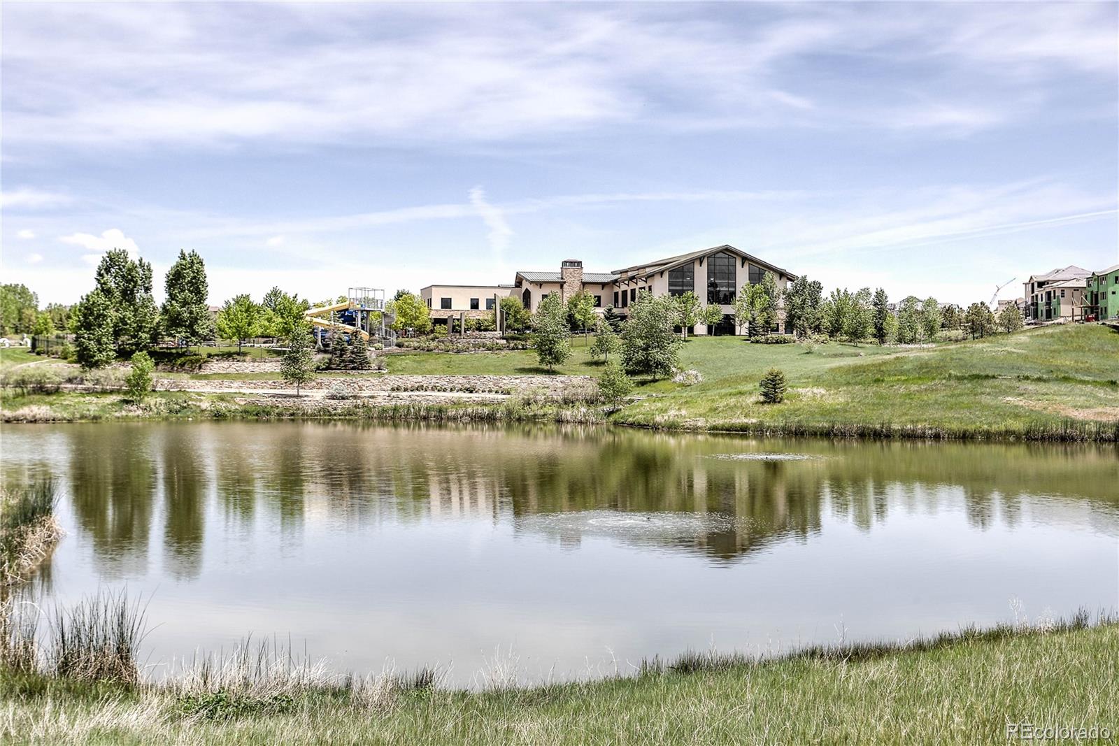 3064 Rams Horn Run Broomfield, CO 80023 - Photo 45 of 47 a view of a lake with a big yard and large trees
