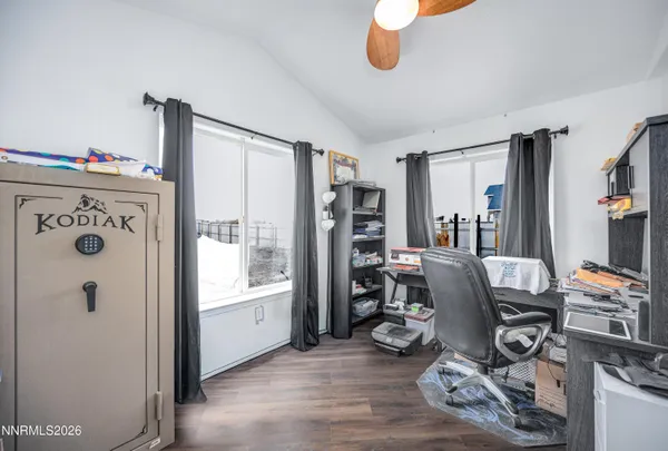 a bedroom with bed and a large window