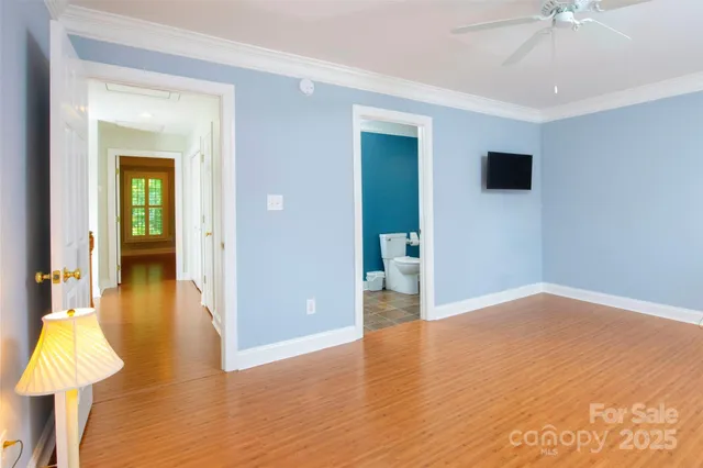 a view of a room with wooden floor and bathroom