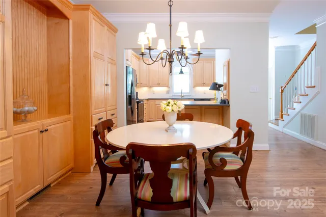 a view of a dining room with furniture and chandelier