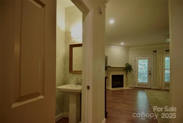 a view of entryway and hall with wooden floor