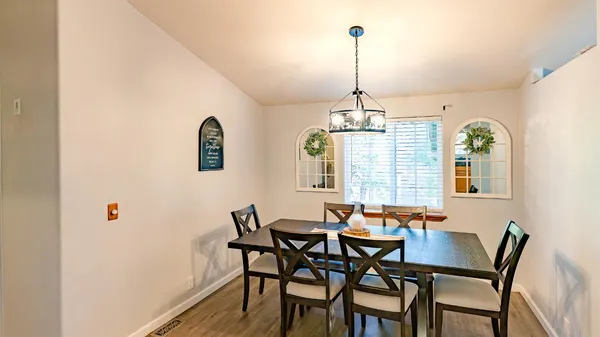 a white house that has a tree in front of it