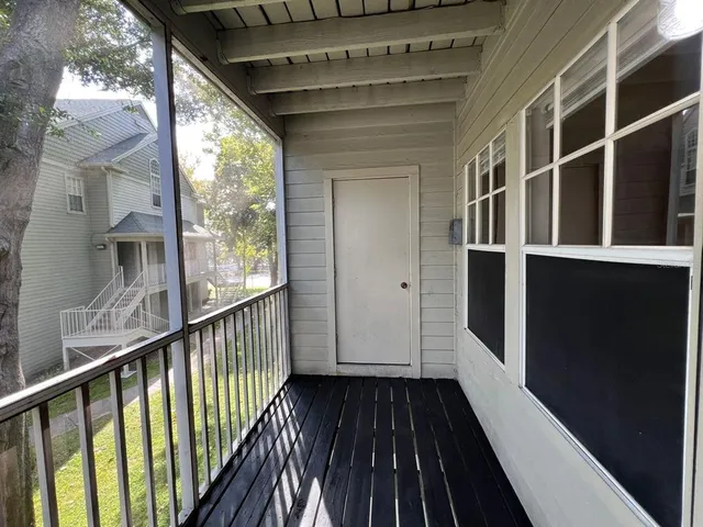a view of balcony with wooden floor