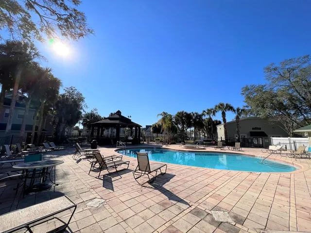 a view of a swimming pool and lounge chairs