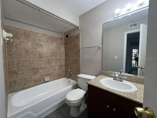 a bathroom with a sink a toilet and bathtub