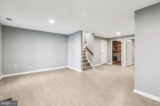 an empty room with a window and stairs