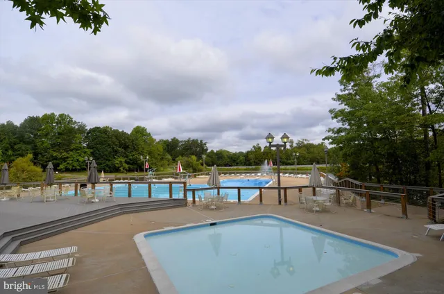 a view of a swimming pool with a yard