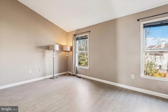 an empty room with windows and closet