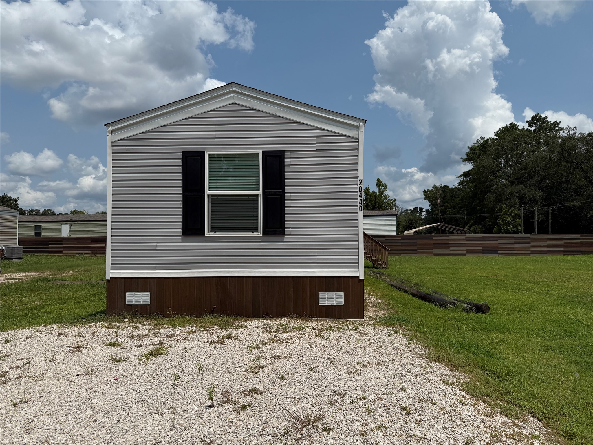 20470 Vick Drive, Unit 20440 New Caney, TX 77357 - Photo 1 of 17 a front view of a house with a yard