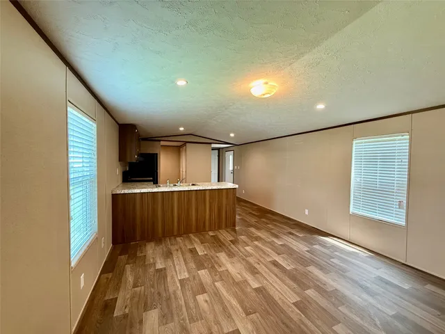 a view of a room with wooden floor