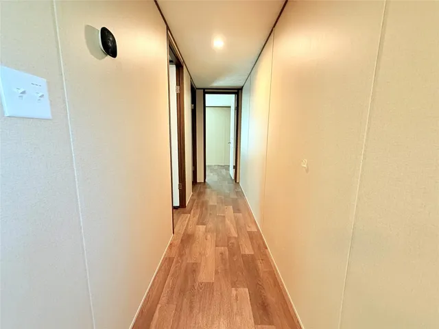 a view of a hallway with wooden floor