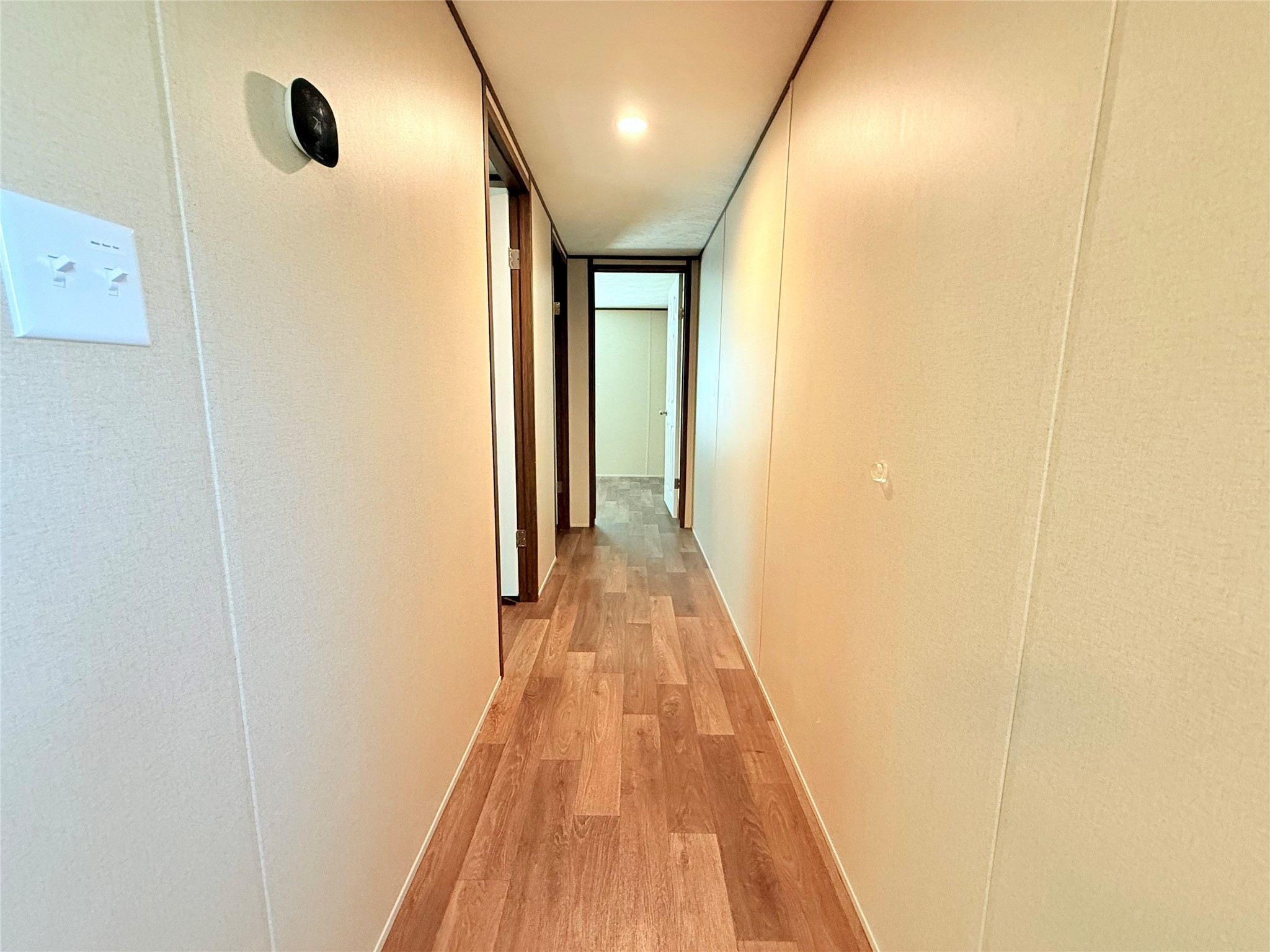 20470 Vick Drive, Unit 20440 New Caney, TX 77357 - Photo 12 of 17 a view of a hallway with wooden floor