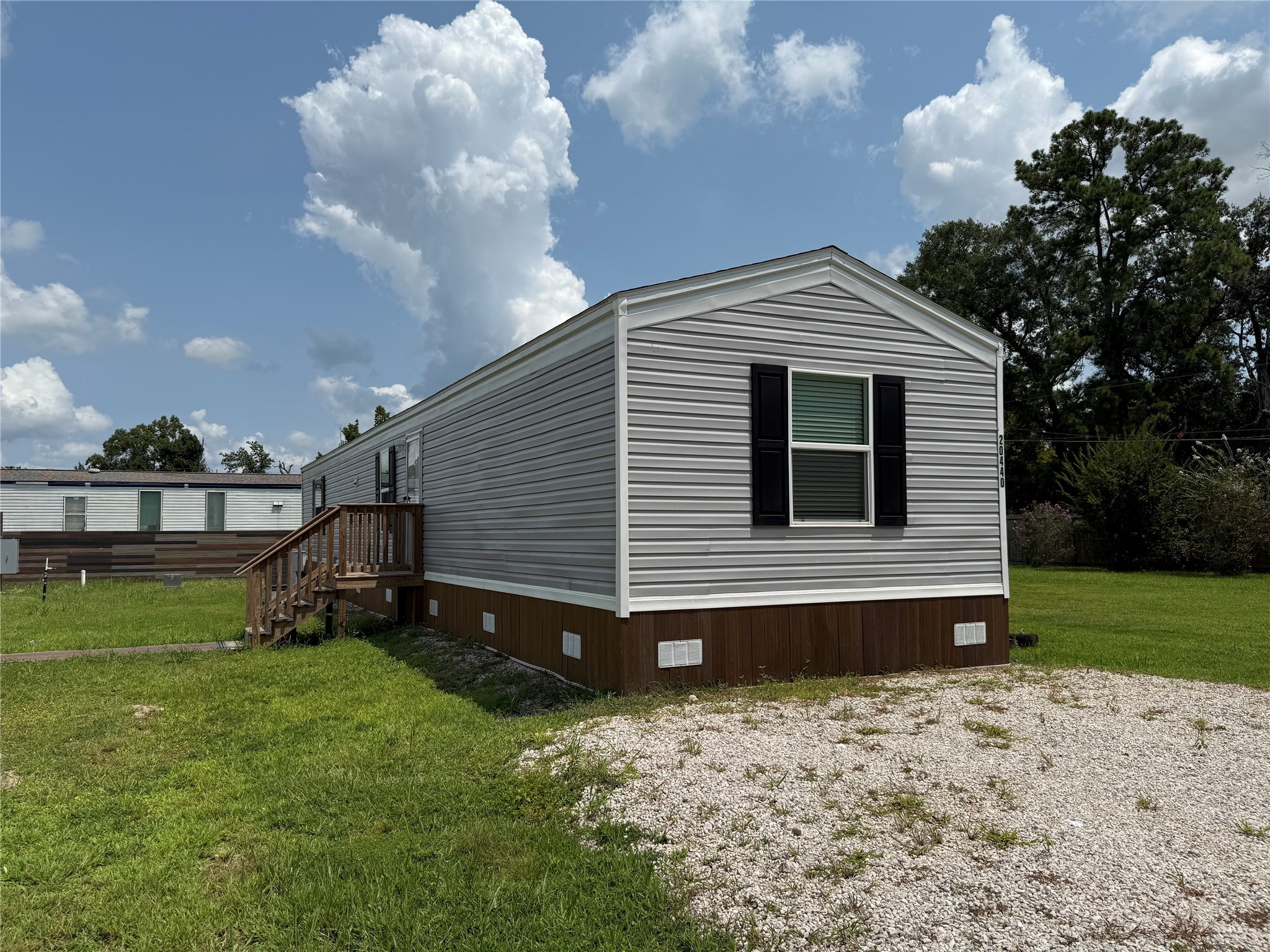 20470 Vick Drive, Unit 20440 New Caney, TX 77357 - Photo 2 of 17 a front view of a house with garden