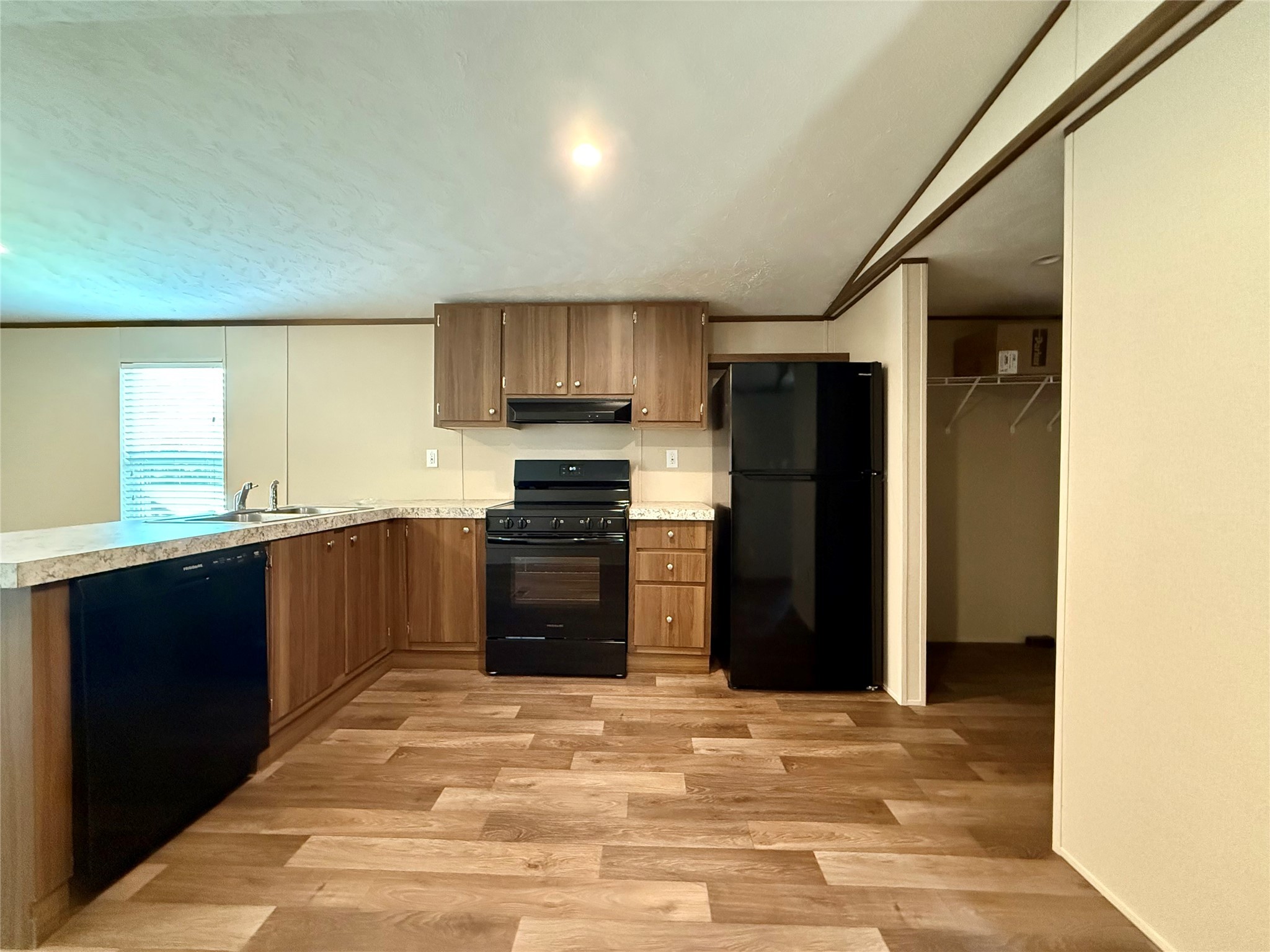 20470 Vick Drive, Unit 20440 New Caney, TX 77357 - Photo 6 of 17 a kitchen with a refrigerator and a stove top oven