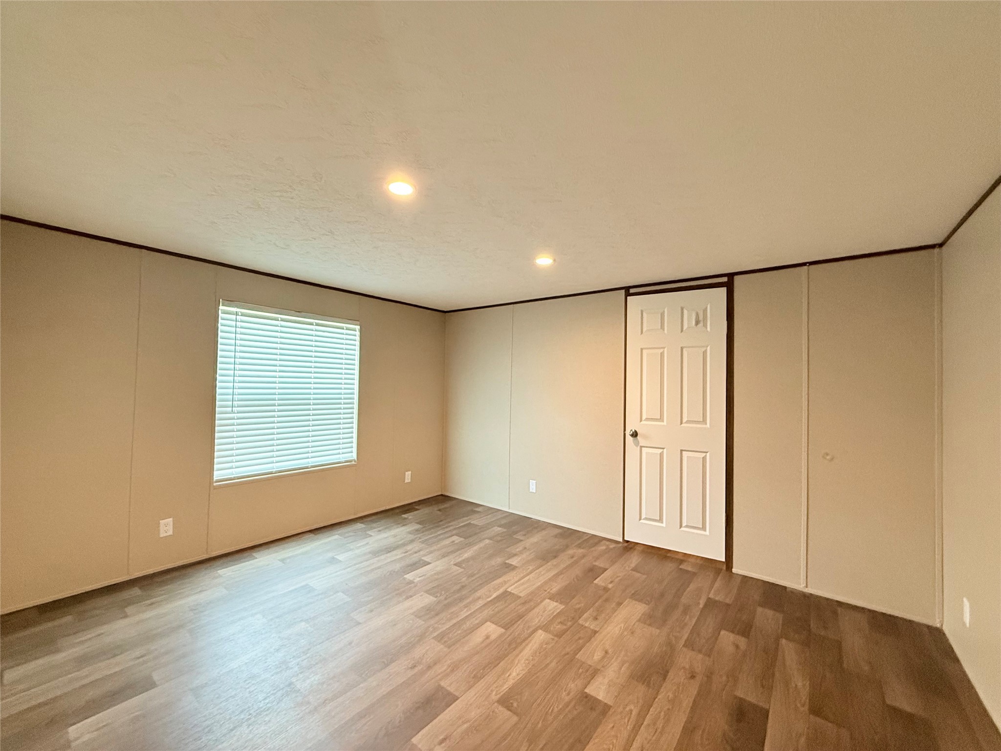 20470 Vick Drive, Unit 20440 New Caney, TX 77357 - Photo 8 of 17 a view of an empty room with wooden floor and a window