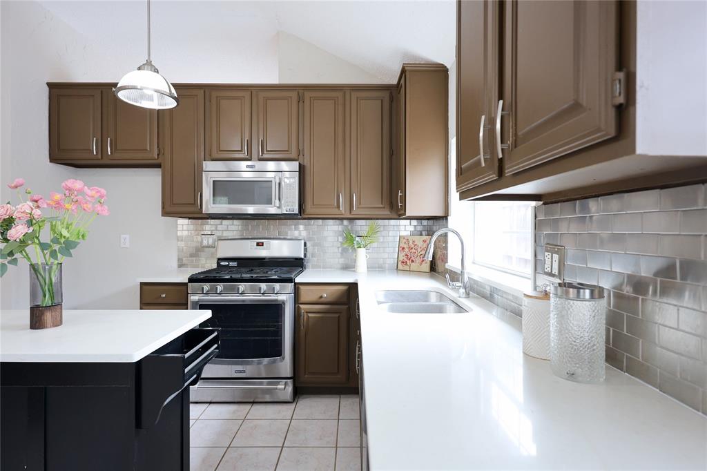 8112 Dock Street Frisco, TX 75035 - Photo 14 of 34 a kitchen with a stove and a microwave