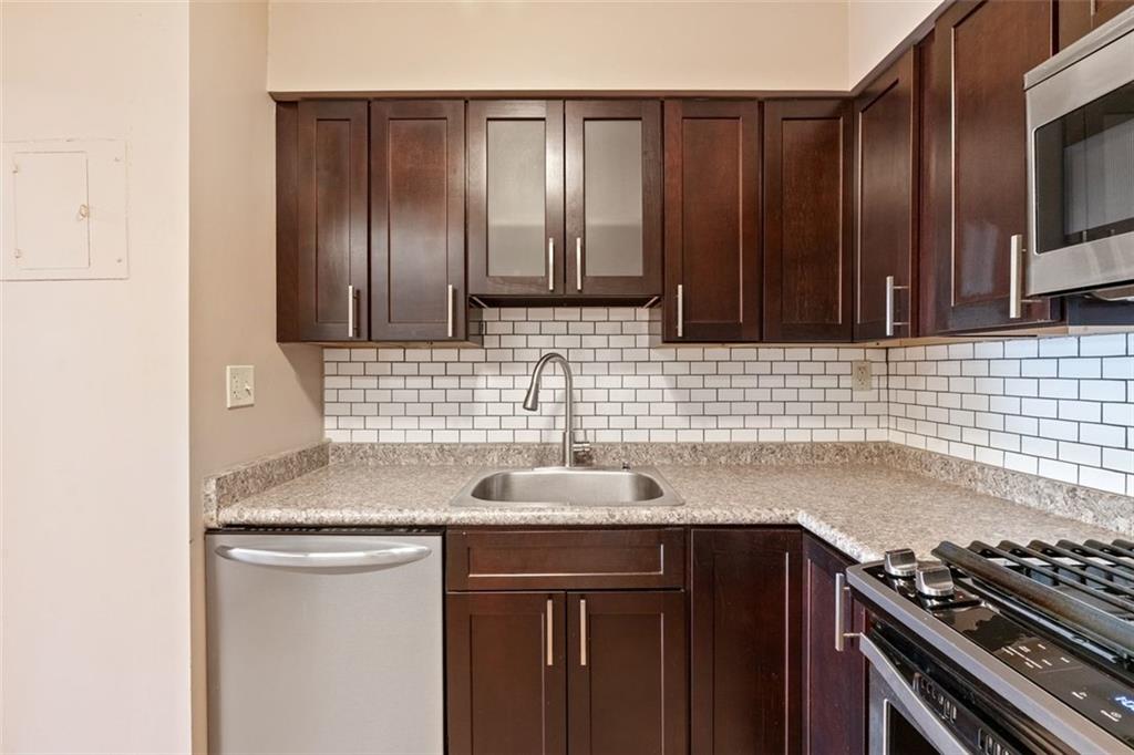 5 Bayard Road, Unit 416 Shadyside, PA 15213 - Photo 12 of 20 a kitchen with stainless steel appliances granite countertop a sink stove and cabinets