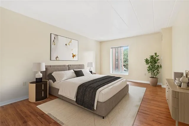 a bedroom with bed and a potted plant