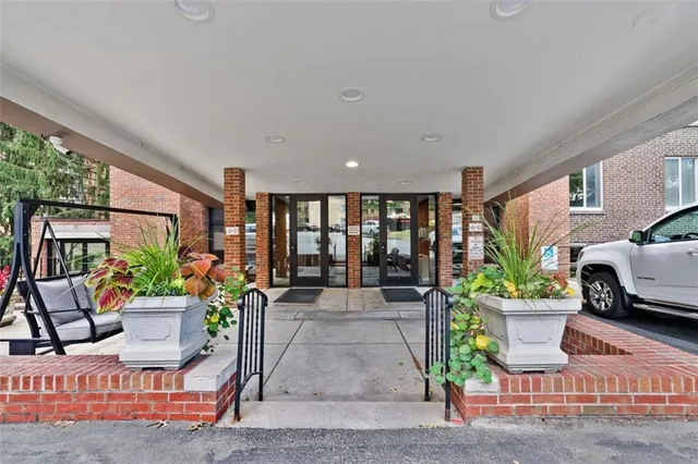 a living room with patio furniture and a potted plant
